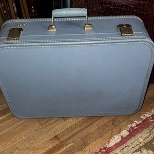 "Vintage Charm: Lady Baltimore Blue Suitcase with Character"